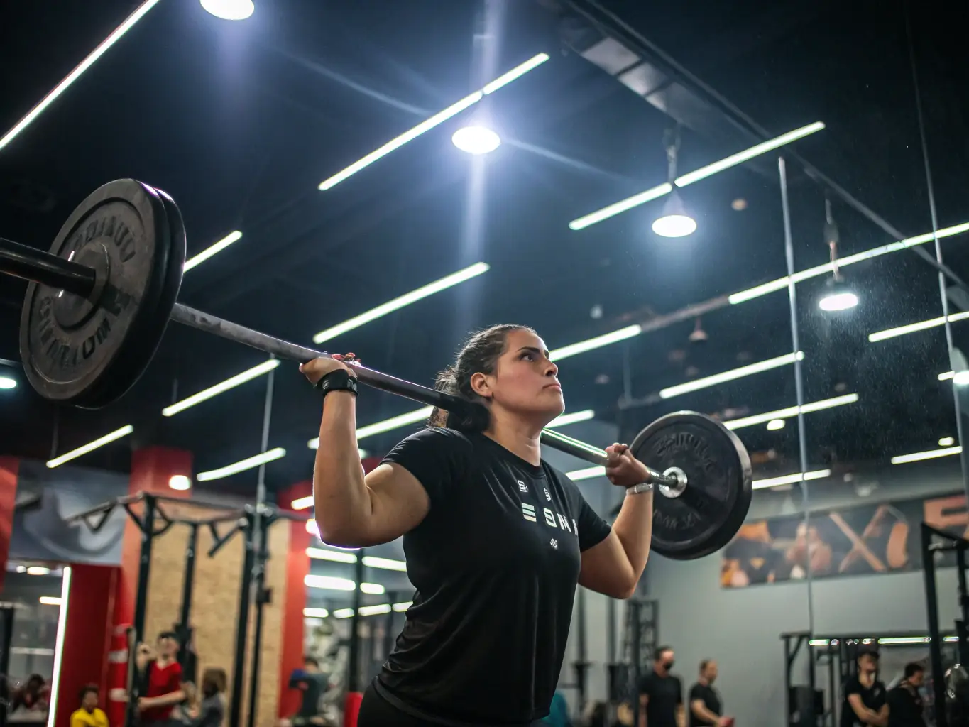 A focused individual lifting weights in a modern gym setting, showcasing strength training and personal fitness. The environment is clean and well-equipped.